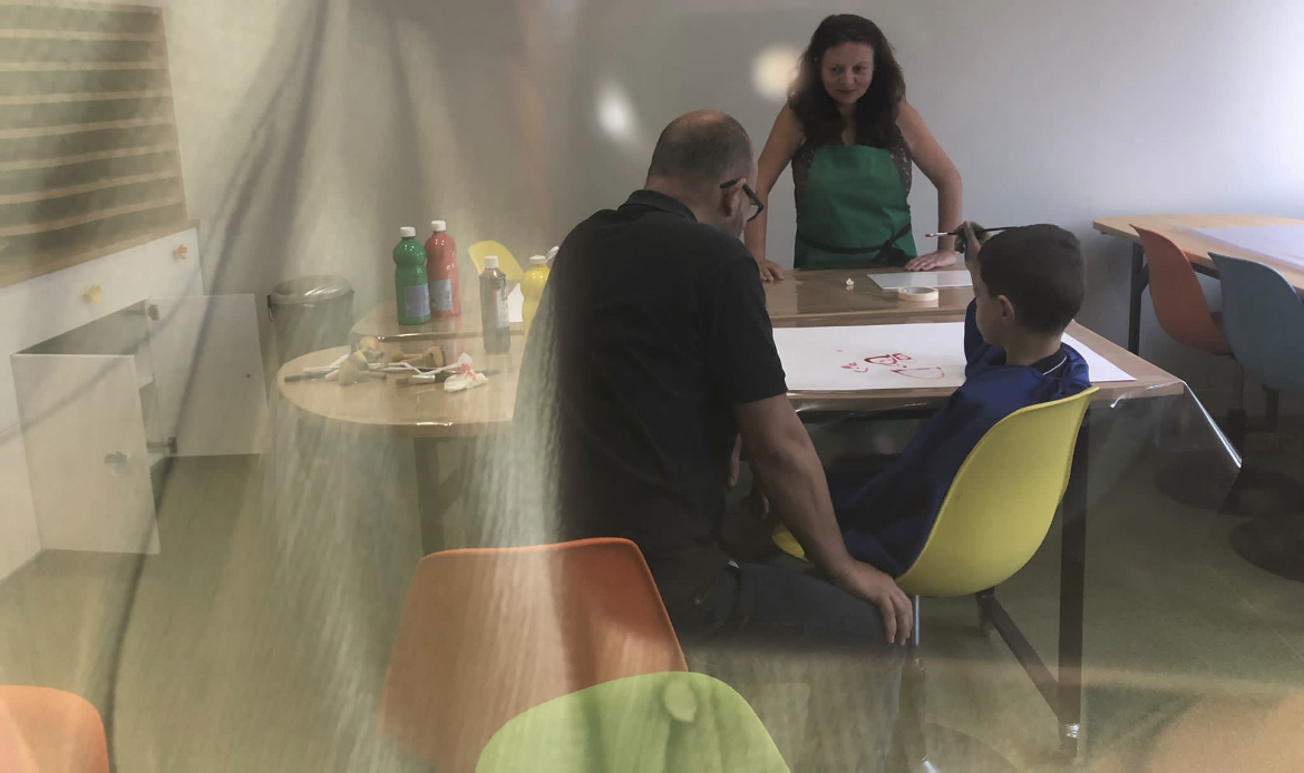 Atelier de peinture entre un enfant et ses accompagnants